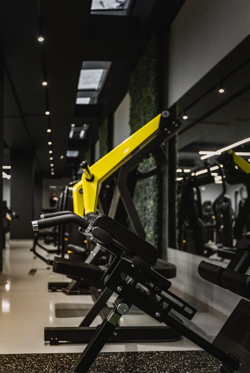 Blackout Fitness gym interior with Technogym equipment and green walls