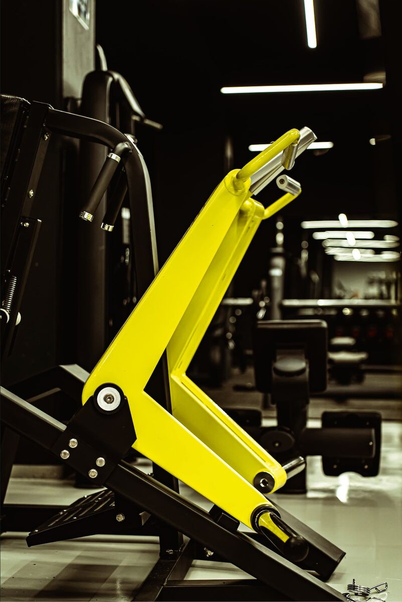 Technogym plate-loaded machine with yellow lever arms